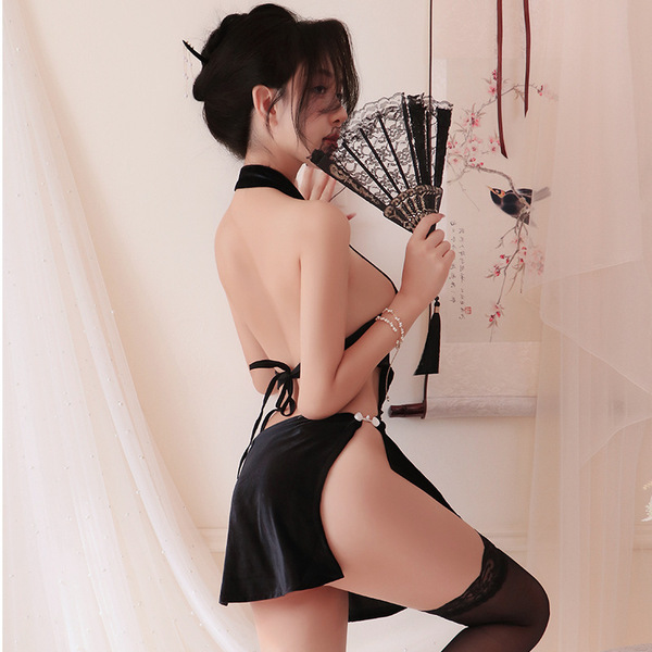 A woman poses elegantly in a black chinese-style sensual lingerie dress featuring high slits, a backless halter design, and e...