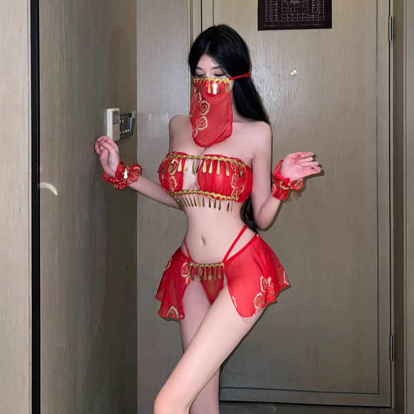 A woman poses in a vibrant red chinese new year-themed costume, featuring an exotic dance-inspired design with intricate patt...