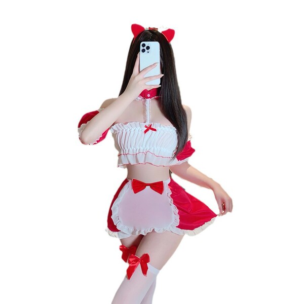 Woman in red and white christmas naughty lingerie set with cat ears, bow accents, and thigh-high stockings for romantic holid...