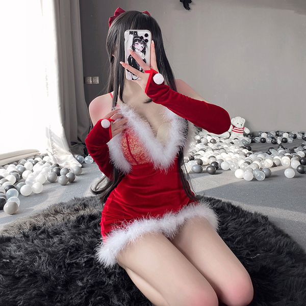 A person poses with a phone, wearing a festive red dress featuring white fur trim and cat ears. the outfit includes long glov...