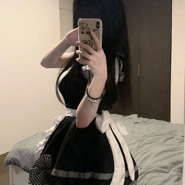 A person wearing a cute maid dress with a black and white checkered skirt, featuring a large bow at the waist. the outfit inc...