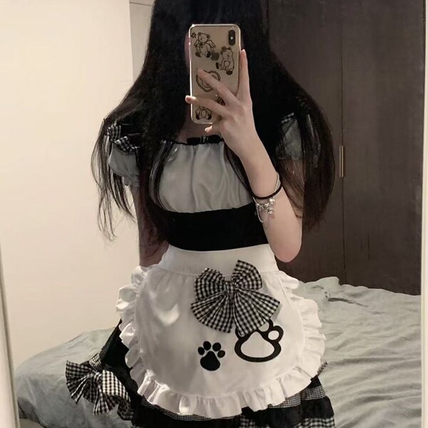 A person wearing a cute maid dress with black and white checkered patterns, featuring bows and cat paw designs, perfect for c...