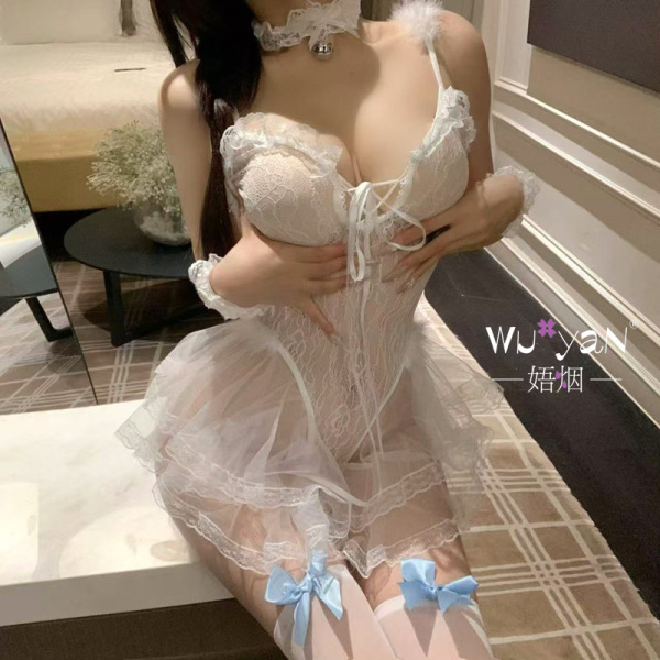 Woman wearing white lace dominatrix-inspired bunny girl lingerie set with blue bows, sheer skirt, and choker.
