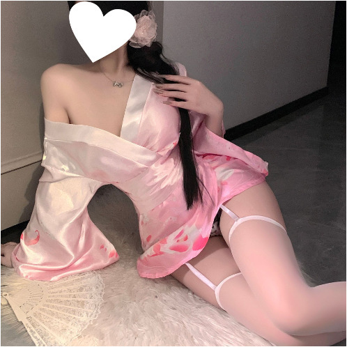 A woman poses wearing a pink domoira temptation lingerie set, featuring a deep v neckline and floral fox dream design, styled...