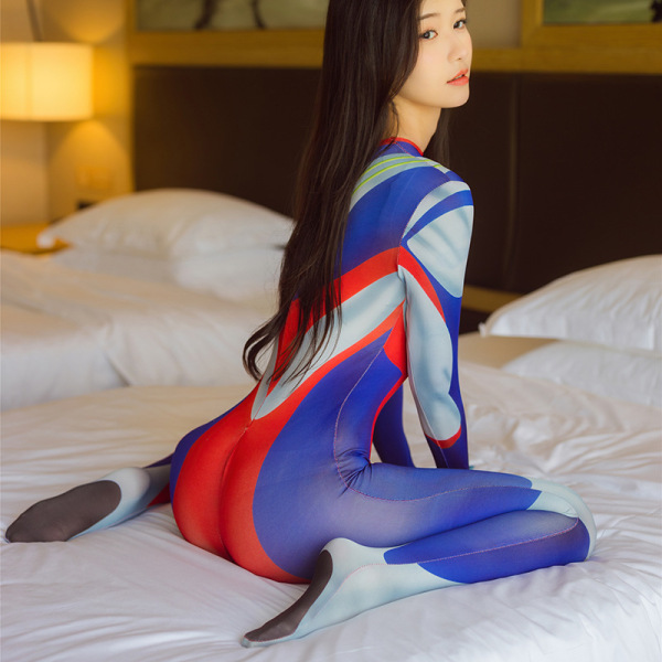 Woman wearing colorful open-crotch bodysuit lingerie set on bed, sexy role play costume with matching sleepwear design.