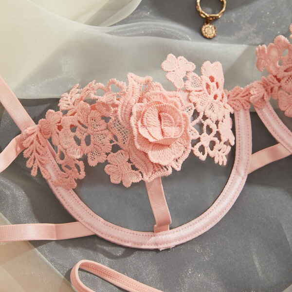 Pink euro-style lace lingerie set with floral embroidery and delicate straps, exuding bold elegance for women.