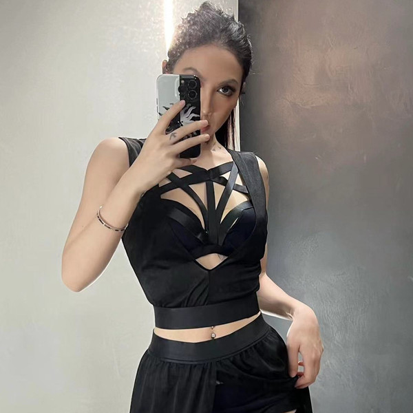 A woman poses in a black european & american style sexy lingerie set featuring an adjustable strap bralette and sheer chiffon...