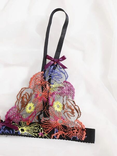 European-style lace bra with vibrant floral embroidery and purple ribbon detail.