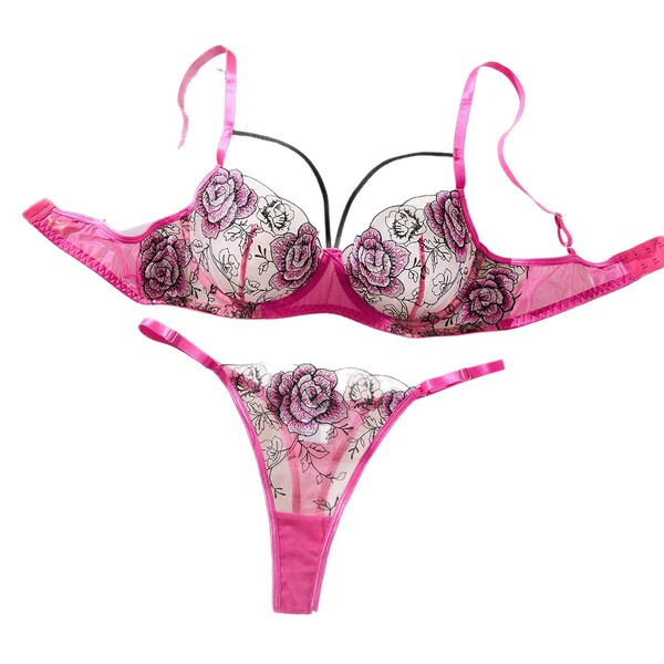 Sheer lace lingerie set with floral embroidery, featuring a transparent bra and matching panty in vibrant pink.