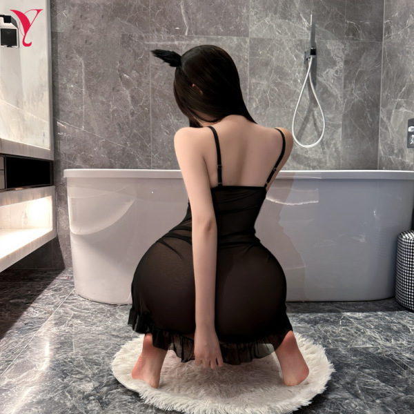 Woman in black feiniao moon gaze sexy sleepwear dress, sheer lace cami slip with alluring fit, kneeling on rug in modern bath...