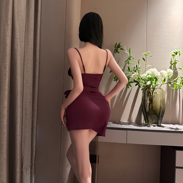 Woman wearing feiniao moonlit lingerie set, a sensual waist-cinching sheer deep v-neck tie-detail sleep dress in burgundy.