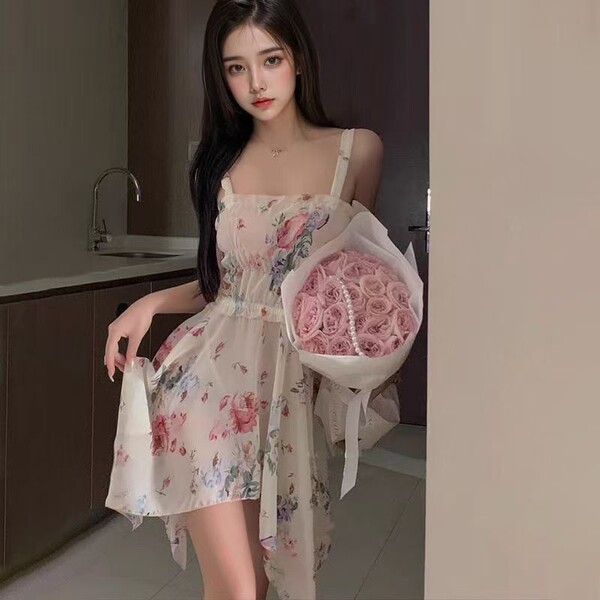 A woman wears a french-inspired lace sleep dress featuring vintage floral patterns, paired with a bouquet of pink roses, crea...