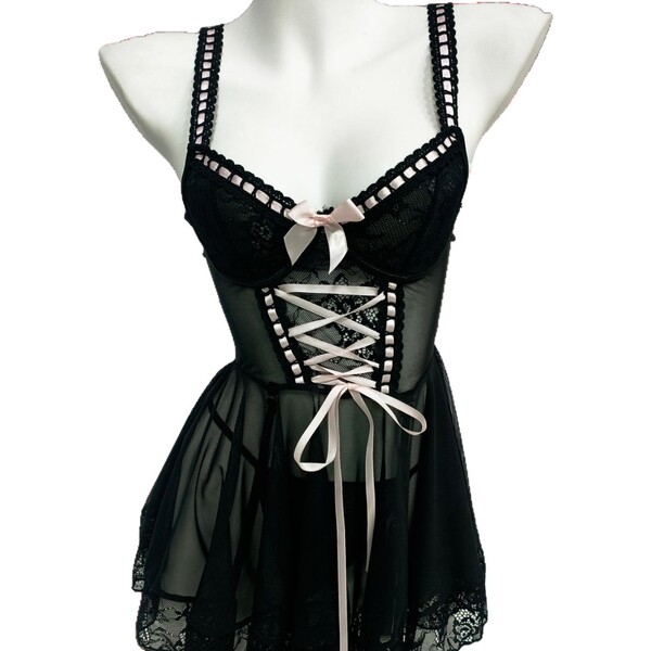 Black lace chemise nightgown with pink ribbon detailing, sheer fabric, and backless design for sensual sleepwear.