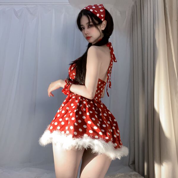 A woman models a festive red polka dot dress with white fur trim, paired with matching bralette and headband, perfect for new...