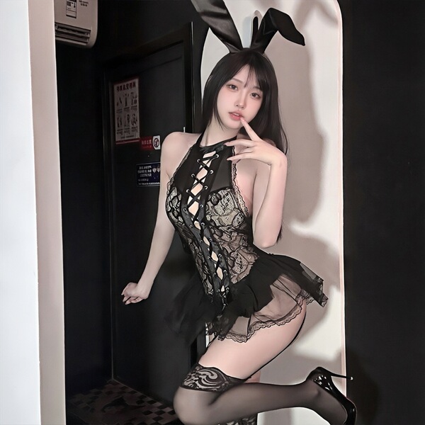 Woman modeling golden night sexy bunny girl lingerie set with lace bodice, bunny ears, and thigh-high stockings.