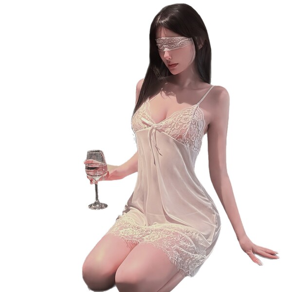 Woman in golden night sexy lingerie set with sheer strapless bra and matching briefs, holding wine glass.