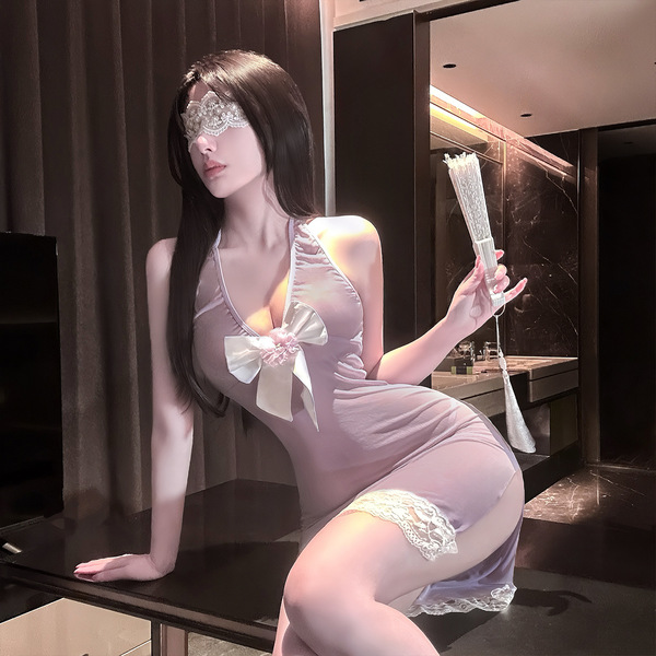 A woman poses elegantly in a sheer lavender lingerie set featuring a sensual butterfly design and delicate lace accents, hold...