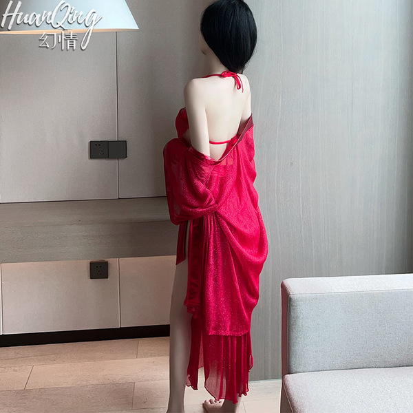 A woman stands facing away from the camera, wearing a vibrant red sheer corset set. the fabric drapes elegantly over her shou...