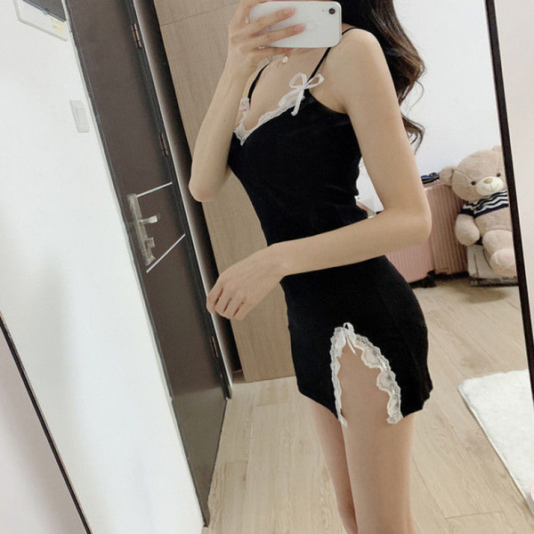 A woman poses in front of a mirror wearing a black hanno sensual lingerie set, featuring lace details and a playful design, p...