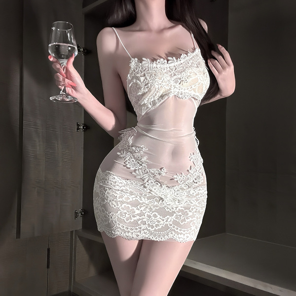 A woman wears a white lace bodysuit with open-crotch design, holding a glass of wine. the outfit features intricate lace deta...