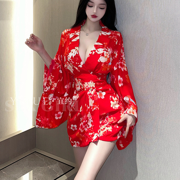 A woman poses in a red japanese cherry blossom-themed sleepwear set, featuring a kimono-style design with floral patterns. th...