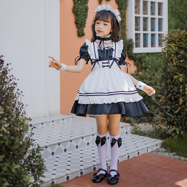 A young girl wears a charming japanese girl black maid dress, featuring ruffled sleeves, a white apron with black trim, and b...