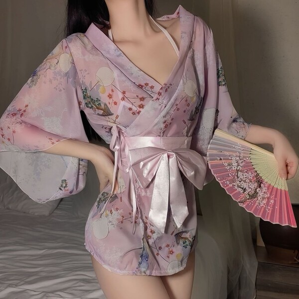 Woman wearing pink floral japanese-inspired lace kimono robe set, holding a fan, showcasing seductive plus size sleepwear and...