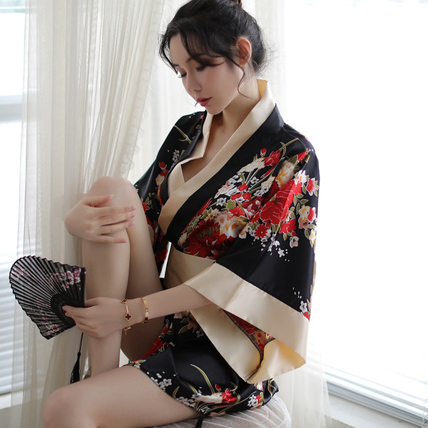 A woman elegantly poses wearing a japanese kimono-style lingerie set, featuring vibrant floral patterns and flowing fabric, p...