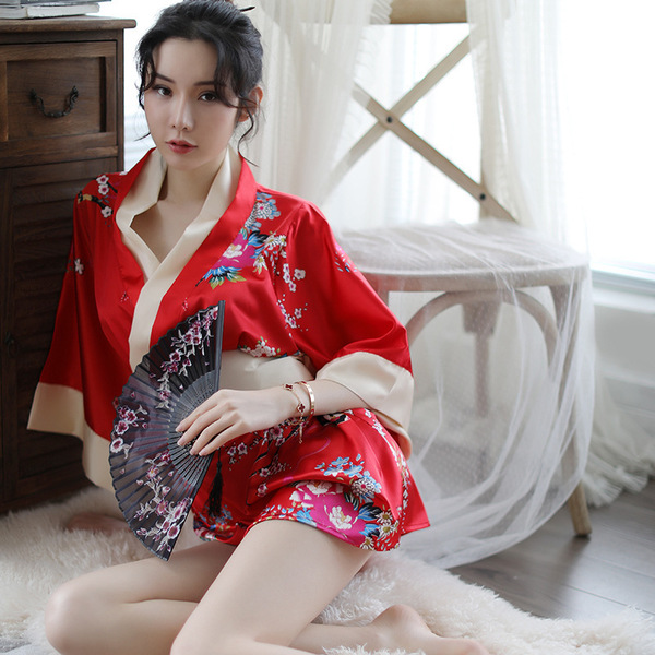 A woman poses elegantly in a vibrant red japanese kimono-style lingerie set, featuring floral patterns and delicate fabric, p...