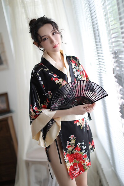 A woman wears a black floral japanese kimono-style lingerie set, holding a fan, exuding elegance and playfulness. perfect for...