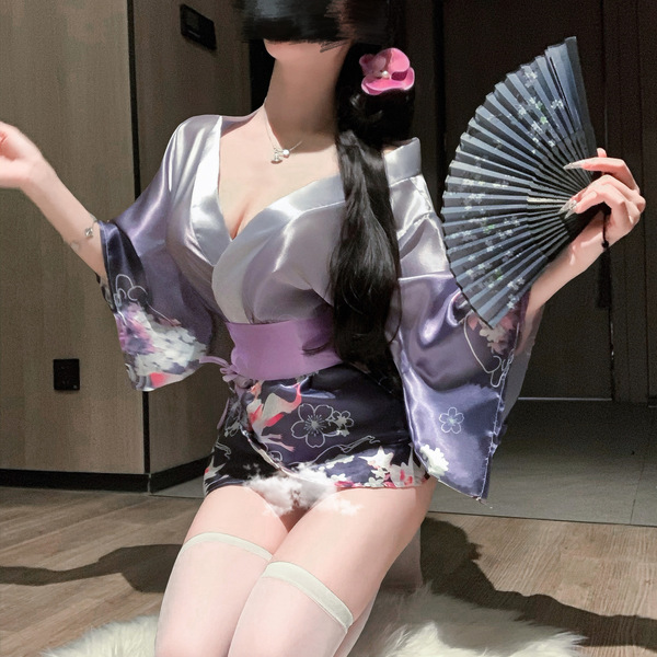 A woman poses wearing a japanese kimono-style lingerie set, featuring floral patterns and elegant design, perfect for role pl...