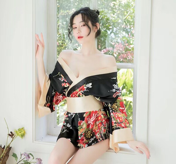 A woman poses elegantly in a japanese-style kimono lingerie set, featuring a floral print design. the off-shoulder top and fl...