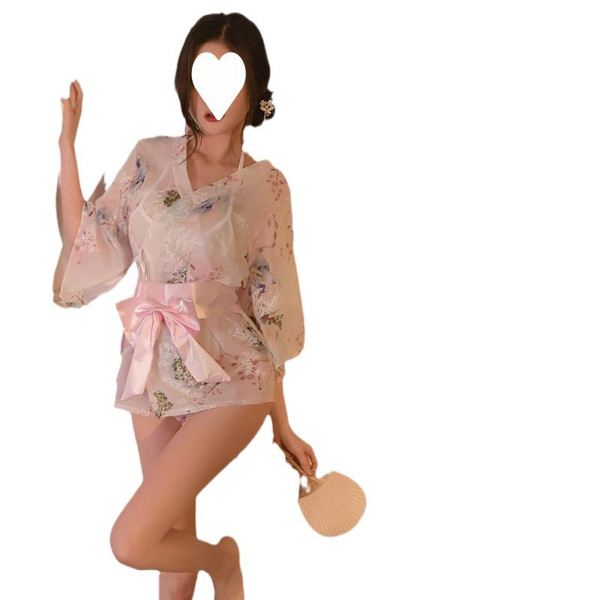 A woman poses wearing a delicate pink floral japanese kimono-style lingerie set, featuring sheer fabric and a heart-shaped fa...