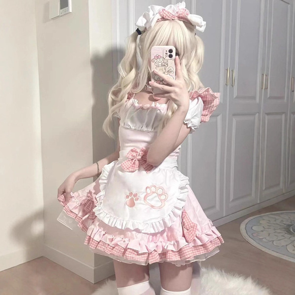 A person wearing a japanese maid cosplay dress featuring a sweet cat theme, with pink and white colors, ruffles, and bows, pe...