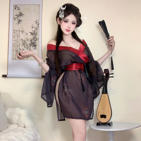 A woman poses elegantly in a japanese-style kimono set, featuring black fabric with floral embroidery and a red sash. she hol...