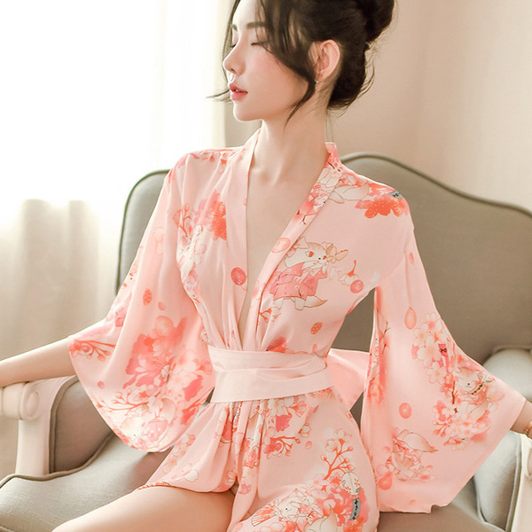 A woman wears a japanese-style sexy lingerie set, featuring a seductive kimono sleepwear with floral patterns and a soft pink...