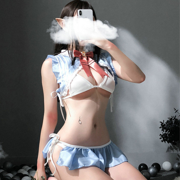 Woman posing in japanese-style sexy maid costume with blue ruffles, white bra, and red bow tie.