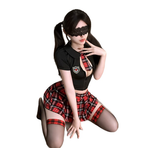 Woman in black top and red plaid skirt, kneeling with hand on chin.
