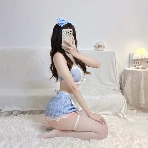 A woman poses in a maid costume set featuring a lace bodice and skirt, complete with stockings and a bow headband, capturing ...
