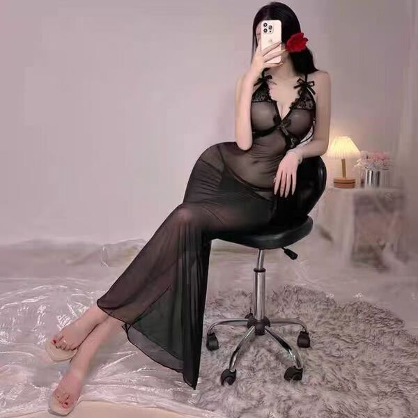 A woman poses in a black sheer lace bodycon dress, featuring delicate lace details and a plunging neckline. the see-through f...