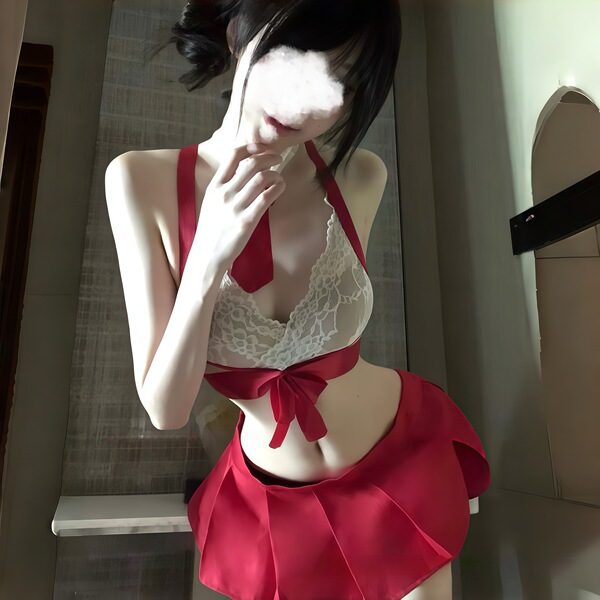 Woman wearing kouni sexy lace bodysuit with skirt, a cute jk-style sleepwear set featuring removable bra and ultra-short skir...