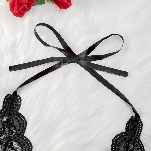 Luxury black lace bodysuit with sheer elegant design, featuring intricate floral patterns and a satin ribbon tie, perfect for...