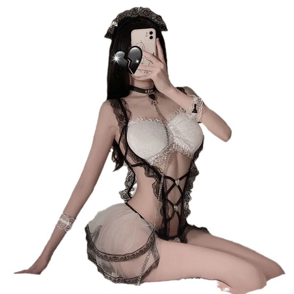 Woman posing in a sexy lace maid costume with an open-crotch design, featuring a white bra, sheer skirt, and black lace trim ...