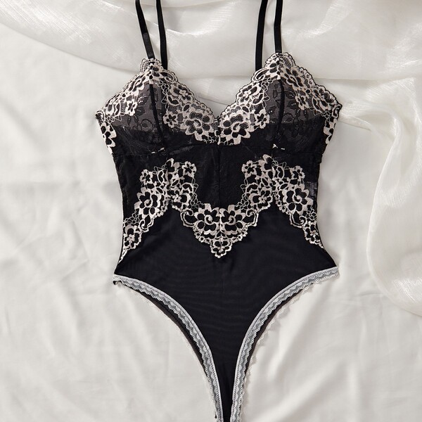 Black lace mesh bodysuit with floral detailing, sheer chemise sleepwear for women, sensual intimate lingerie set on white fab...