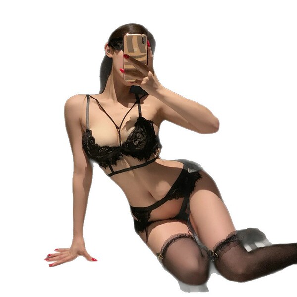 Woman wearing black lace see-through bikini set, featuring transparent lingerie with seductive costume style design.