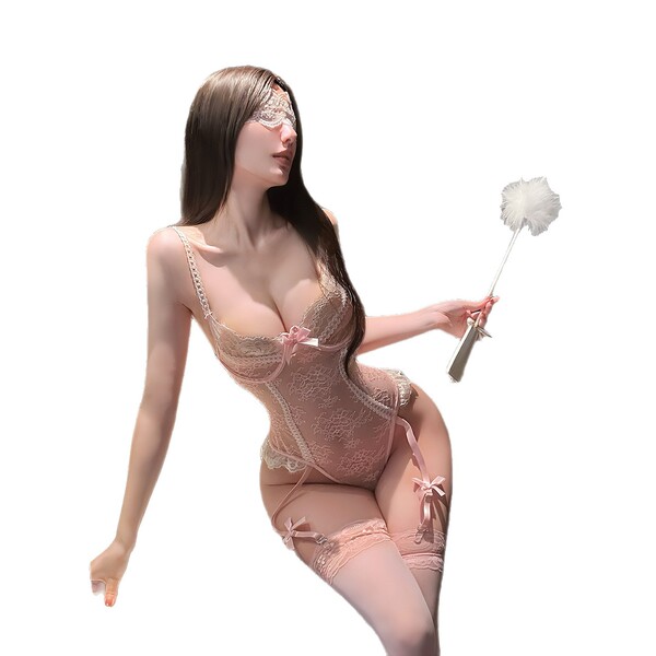 Woman in pink lace bodysuit with sheer bust, holding a feather wand.