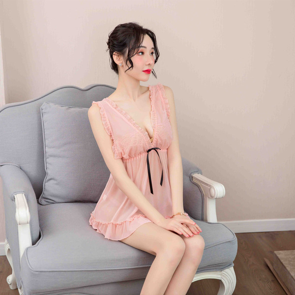 A woman sits gracefully on a chair wearing an adorable sheer nightgown, featuring lace details and a side slit design, perfec...