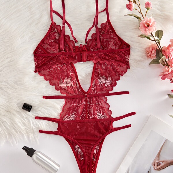 Red lace sheer bodysuit for women, featuring intricate floral patterns and delicate straps, styled with soft pink flowers and...