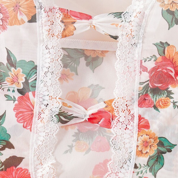 Floral lace sheer bodysuit with delicate bows and intricate detailing, perfect for a feminine and elegant look.