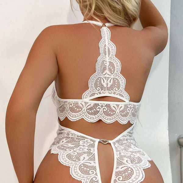 Woman wearing white lace sheer open-crotch bodysuit, sexy sleepwear with intricate back design, -style erotic lingerie.